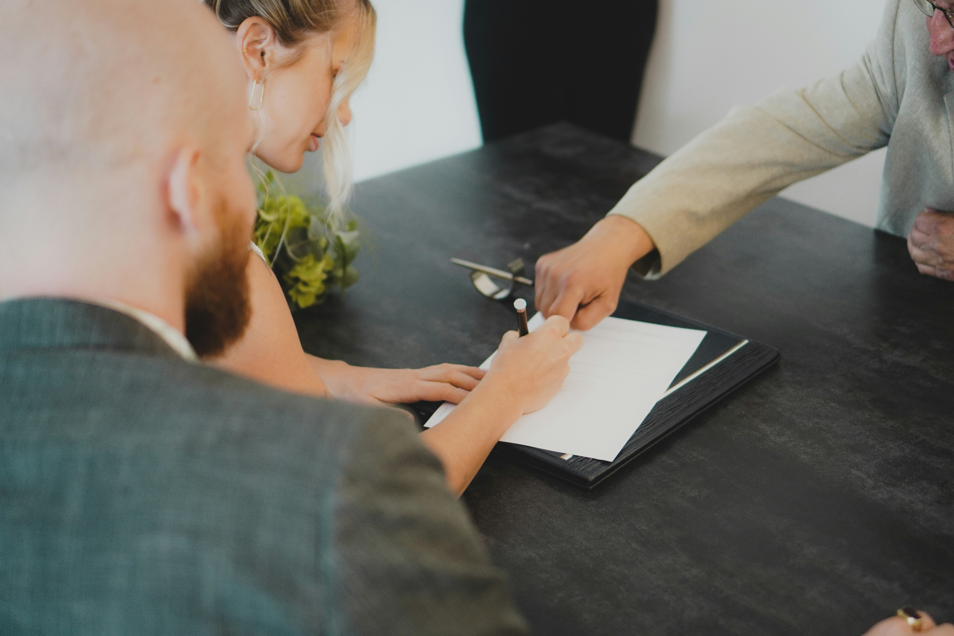 Client signing legal documents with guidance